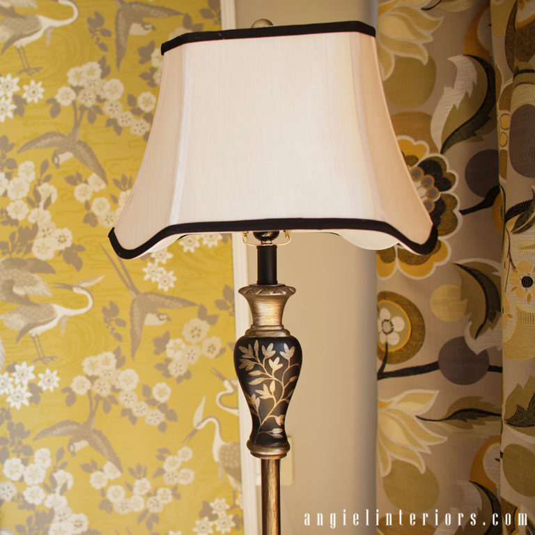 GR&J Baker Heron wallpaper in yellow and grey dining room with Mid-century modern dining set and brass accents