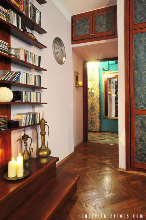 Dark blue floral wallpaper on shutter doors and walnut hardwood floors