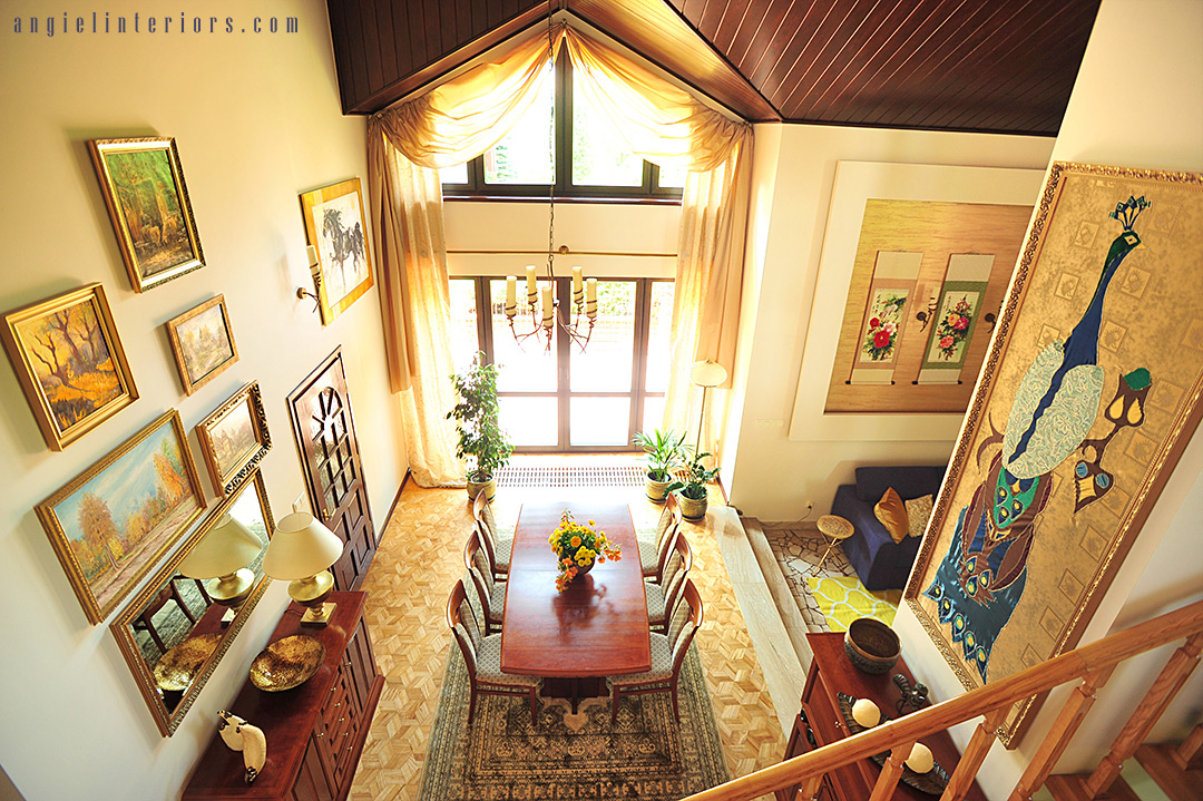 Two story dining room with vaulted ceiling and triangle window