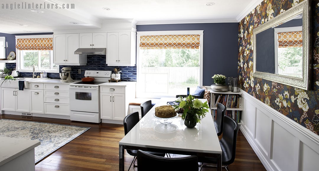 Dining area in white kitchen with high gloss white table and six modern leather chairs